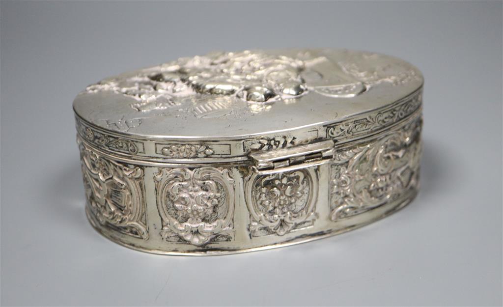 A late 19th/early 20th century German embossed 800 white metal oval box with hinged cover, 13.4cm,